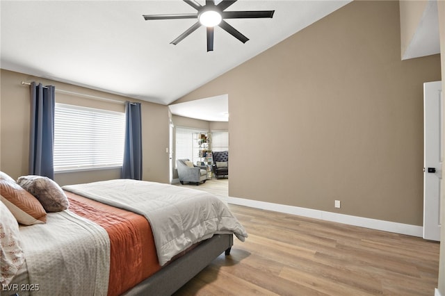 bedroom with vaulted ceiling, ceiling fan, and light hardwood / wood-style floors