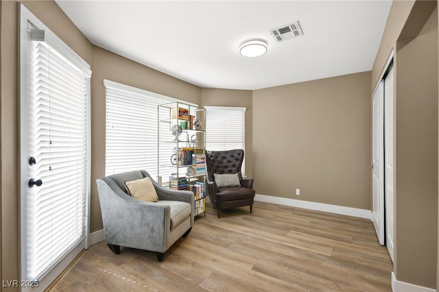 sitting room featuring light hardwood / wood-style floors