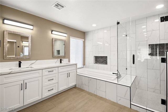 bathroom featuring vanity and separate shower and tub