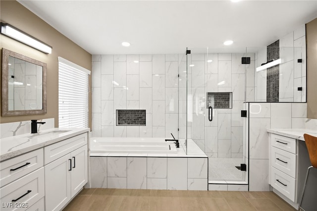 bathroom with vanity and separate shower and tub