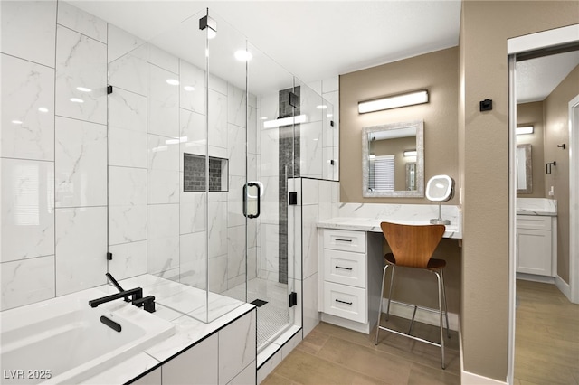 bathroom with vanity and shower with separate bathtub