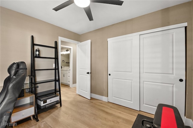 home office featuring light hardwood / wood-style flooring and ceiling fan