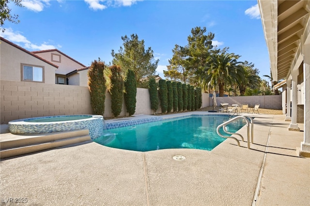 view of swimming pool featuring an in ground hot tub and a patio area