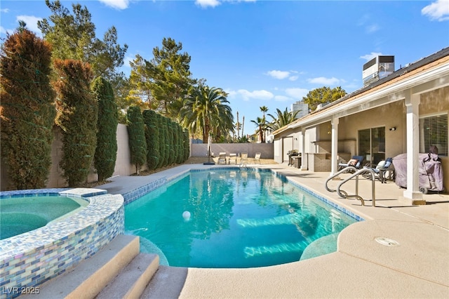 view of swimming pool featuring an in ground hot tub and a patio