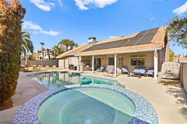 view of swimming pool featuring a patio and an in ground hot tub