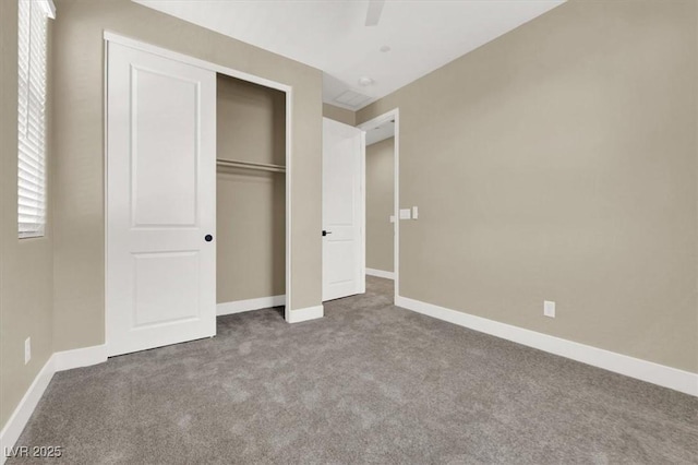 unfurnished bedroom with a closet, ceiling fan, and carpet flooring