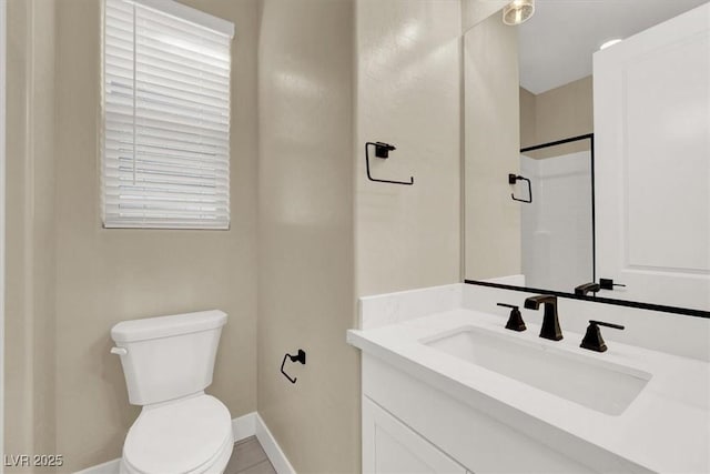 bathroom featuring tile patterned flooring, vanity, and toilet