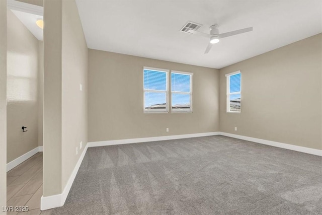 spare room with light carpet and ceiling fan