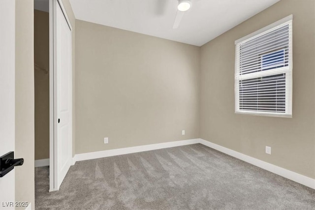 unfurnished room with ceiling fan and light colored carpet