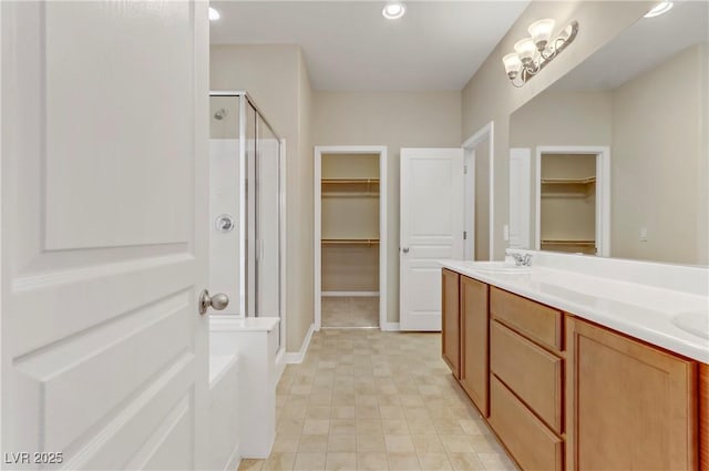 bathroom with vanity and separate shower and tub