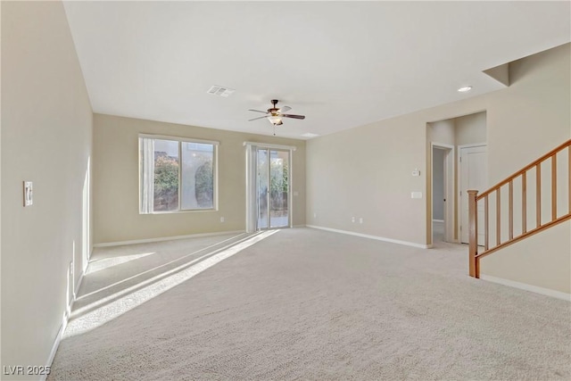 unfurnished living room featuring light carpet and ceiling fan