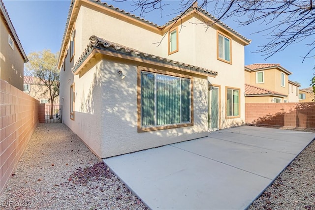 back of property featuring a patio