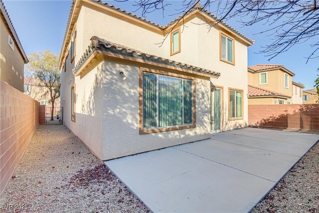 7659 Dewy Falls Ave, Las Vegas, NV 89179 - rear view of house with stucco siding, a patio, a fenced backyard, and a tiled roof