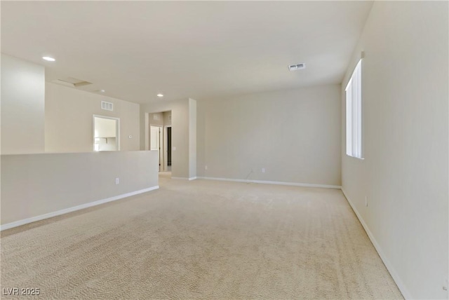 unfurnished room with light colored carpet