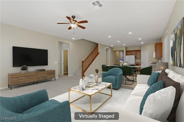 living room featuring ceiling fan and light colored carpet