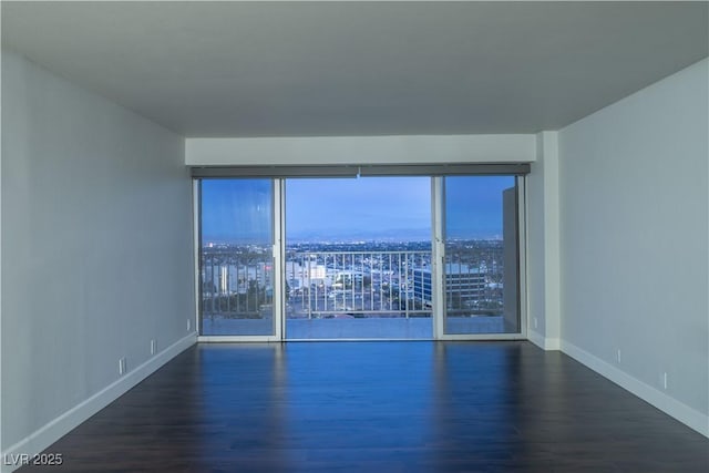 spare room featuring dark hardwood / wood-style flooring