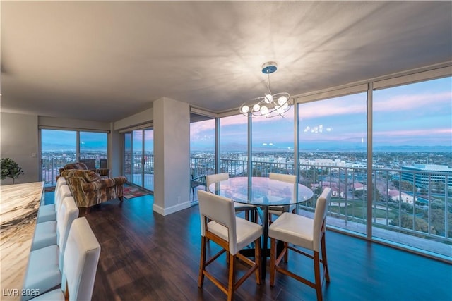 dining room with expansive windows, dark hardwood / wood-style flooring, and a chandelier