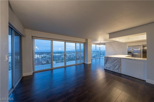 unfurnished living room featuring dark wood-type flooring