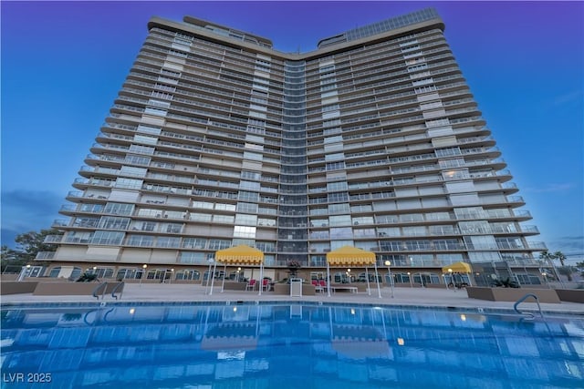 view of pool at dusk