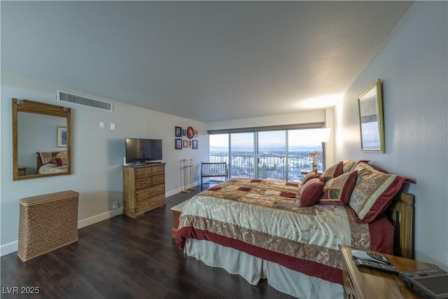 bedroom with dark hardwood / wood-style floors