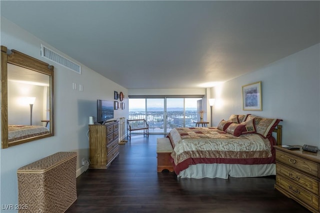 bedroom with dark hardwood / wood-style flooring and access to outside