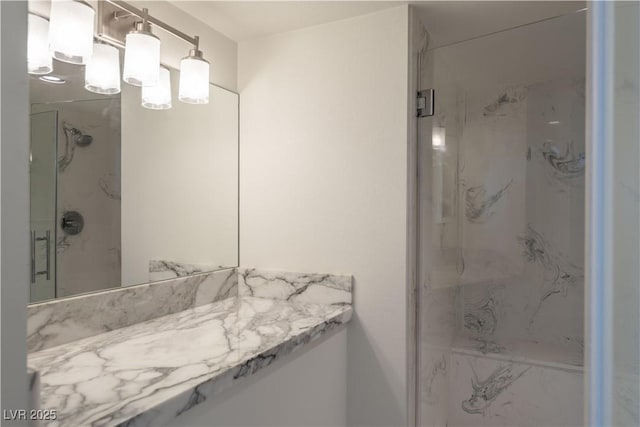 bathroom featuring vanity and an enclosed shower