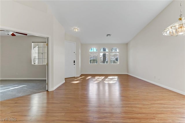 unfurnished living room with ceiling fan, lofted ceiling, and light hardwood / wood-style floors