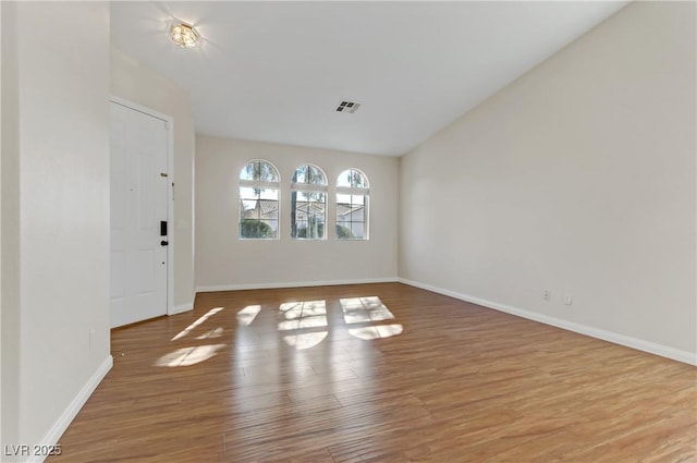 unfurnished room with hardwood / wood-style floors