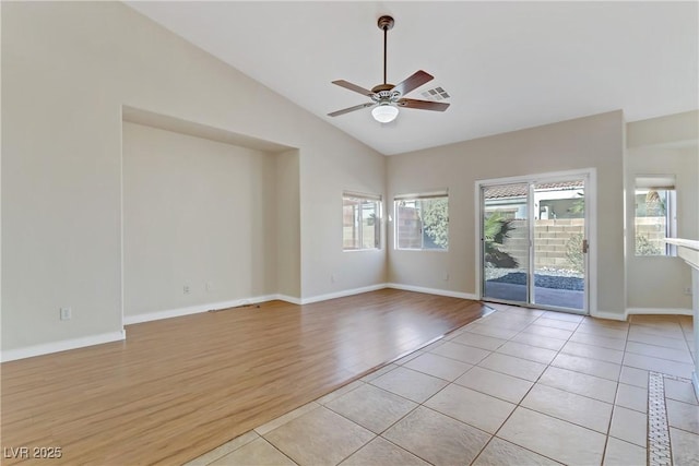 empty room with vaulted ceiling, ceiling fan, and light wood-type flooring