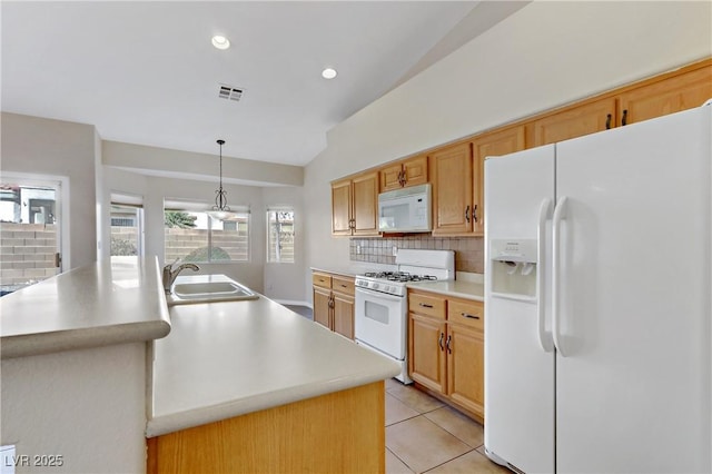 kitchen with sink, white appliances, backsplash, a center island with sink, and decorative light fixtures