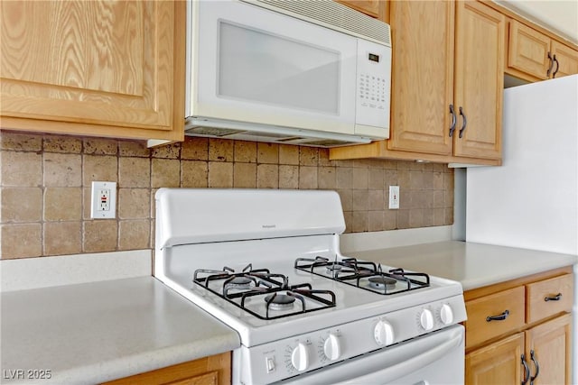 kitchen with tasteful backsplash, white appliances, and light brown cabinets