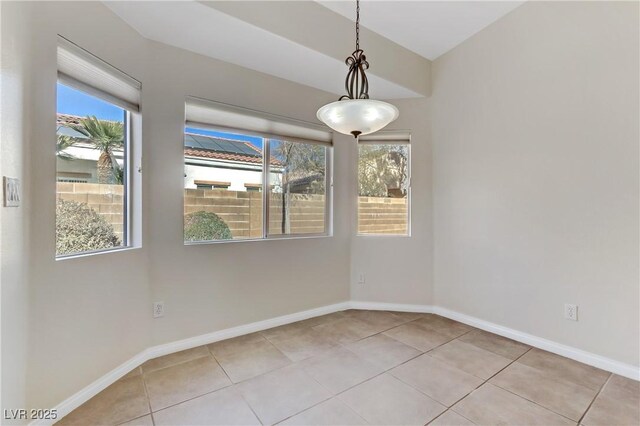 tiled empty room featuring plenty of natural light