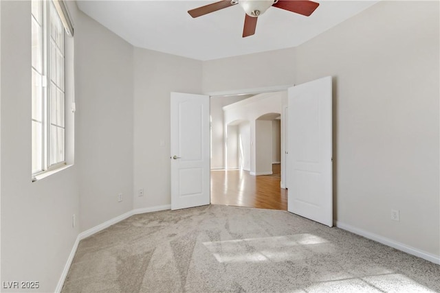 spare room featuring ceiling fan and light colored carpet