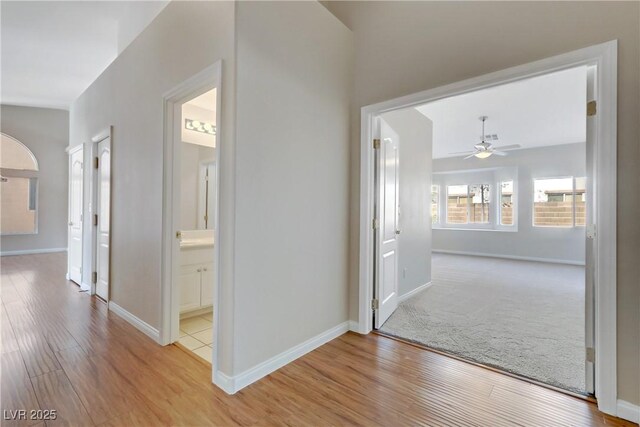 corridor with light hardwood / wood-style flooring