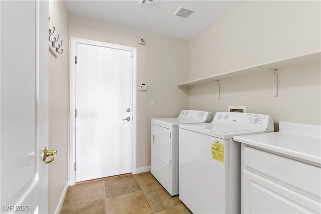 washroom with light tile patterned floors and washer and clothes dryer