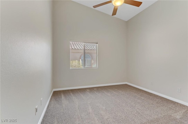 carpeted spare room with ceiling fan and vaulted ceiling