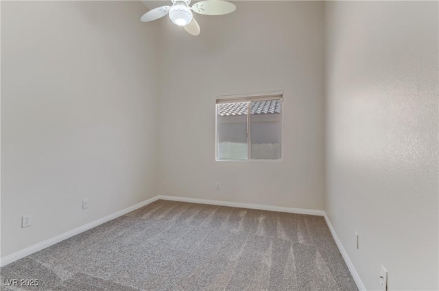 spare room featuring ceiling fan and carpet floors