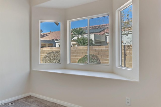 interior space featuring carpet flooring and a wealth of natural light