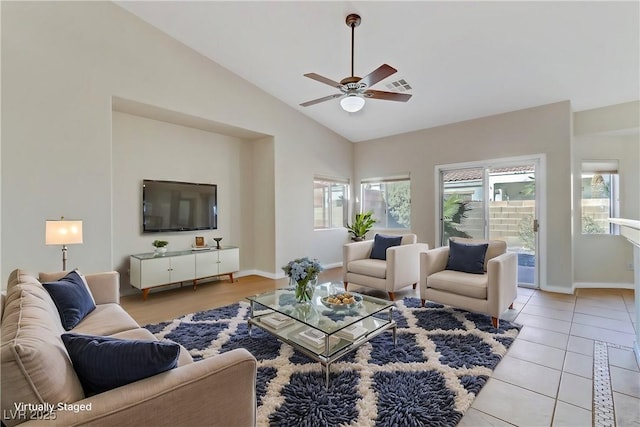 living room featuring light tile patterned floors, vaulted ceiling, and ceiling fan