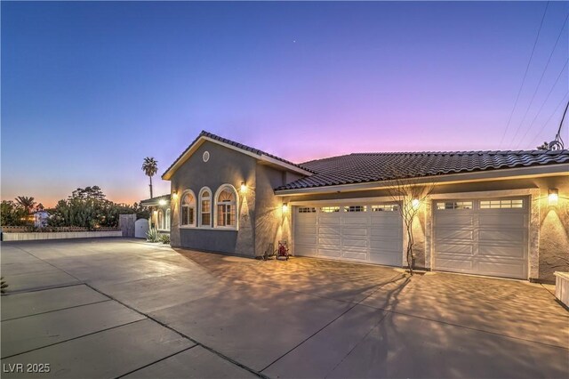 mediterranean / spanish-style house with a garage