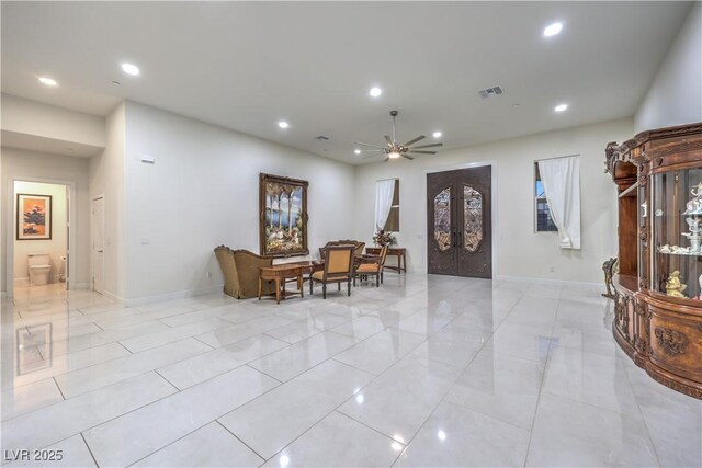 living room with french doors and ceiling fan