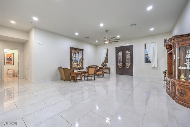 interior space with french doors and ceiling fan