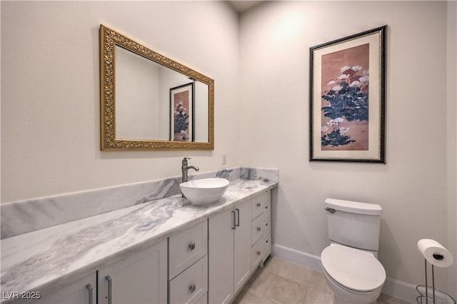 bathroom with vanity, toilet, and tile patterned flooring