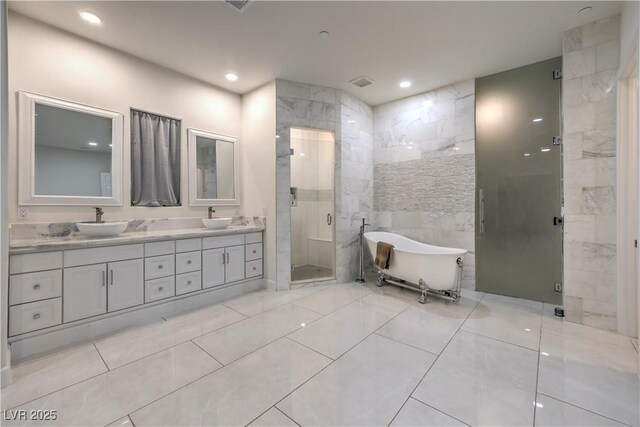 bathroom featuring vanity, separate shower and tub, and tile walls