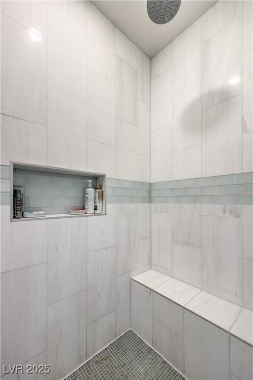 bathroom with tiled shower