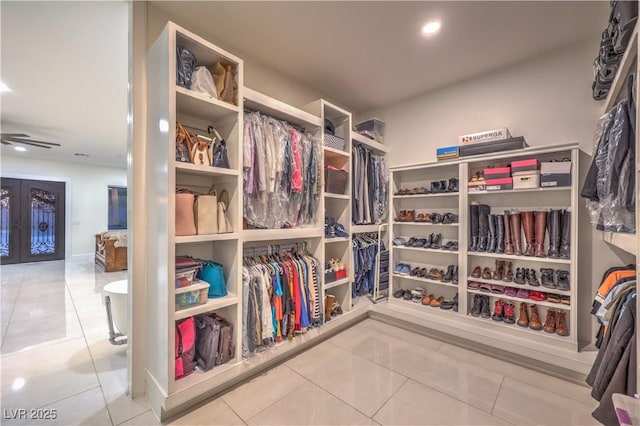 walk in closet featuring french doors and tile patterned floors