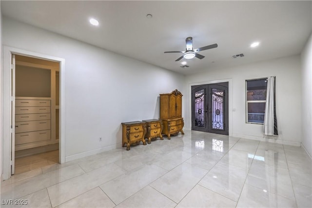 interior space with ceiling fan and french doors