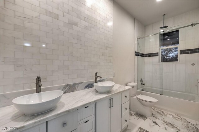 full bathroom featuring vanity, backsplash, toilet, and combined bath / shower with glass door