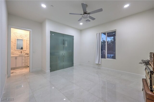 spare room with ceiling fan and sink