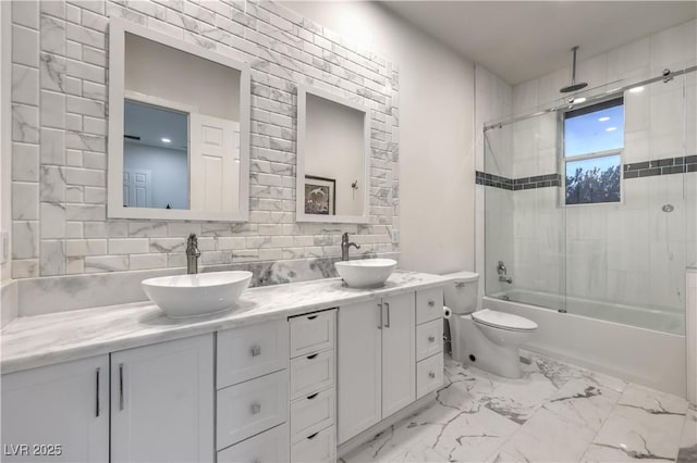 full bathroom featuring tasteful backsplash, vanity, shower / bath combination with glass door, and toilet